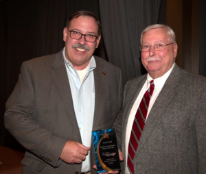 Allan Pavlick (left), vice president of Stertil ALM congratulated by Streator Mayor, Jimmy Lansford (right).