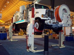 A Vac-Con truck sits atop mobile column lifts. Stertil-Koni and Vac-Con often partner at trade shows across the country.